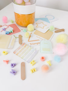 GoodnightFox Back to School Sensory Jar with pastel school pieces, shapes, letters and loose sensory materials.